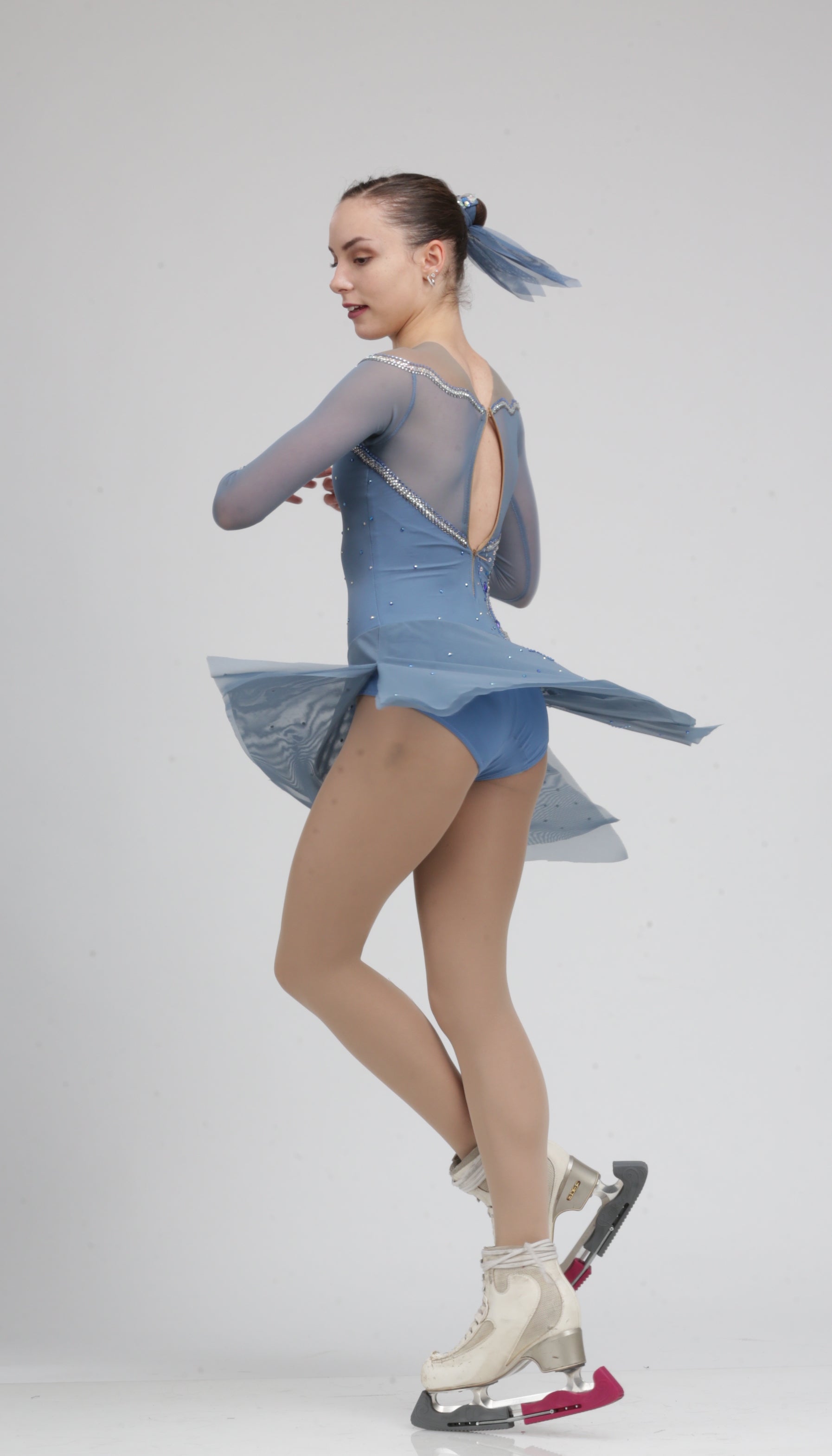 Stunning long sleeve pale blue Ice skating dress figure skating dress embroidered with Aurum Swarovski crystals.